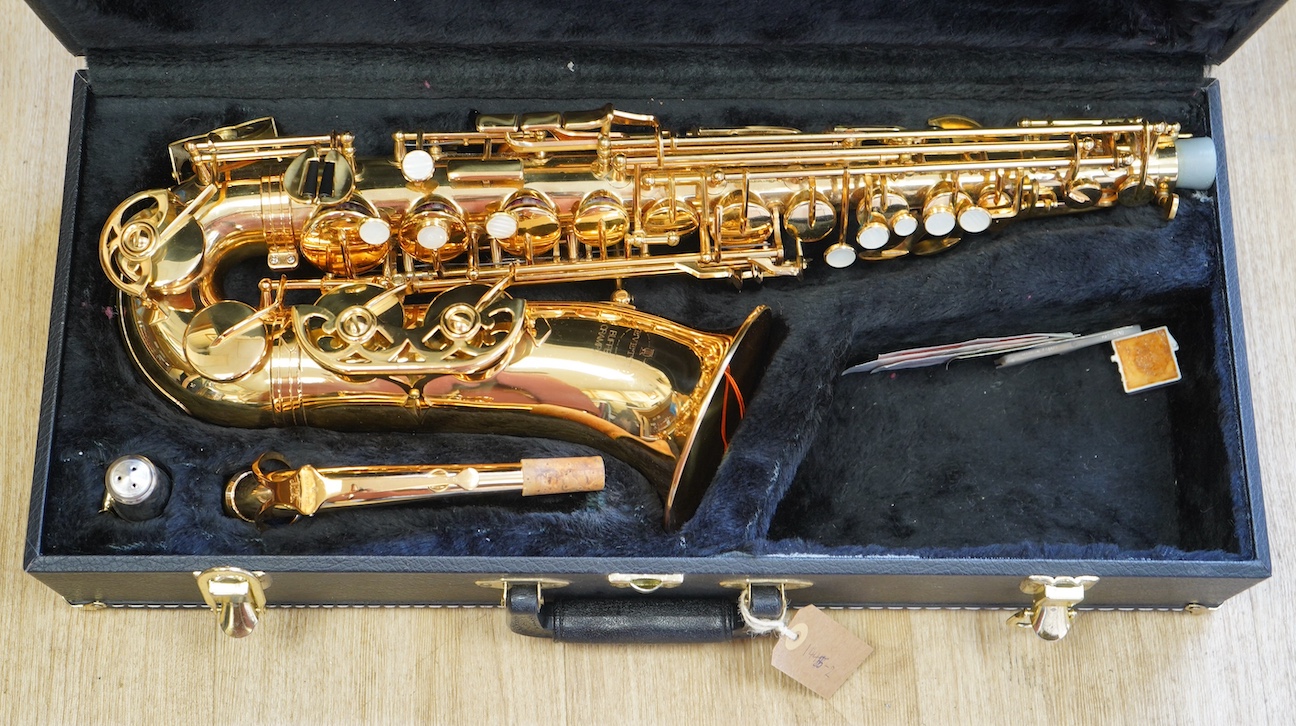 A cased Evette Buffet Crampon brass alto saxophone, together with a saxophone stand. Condition - good